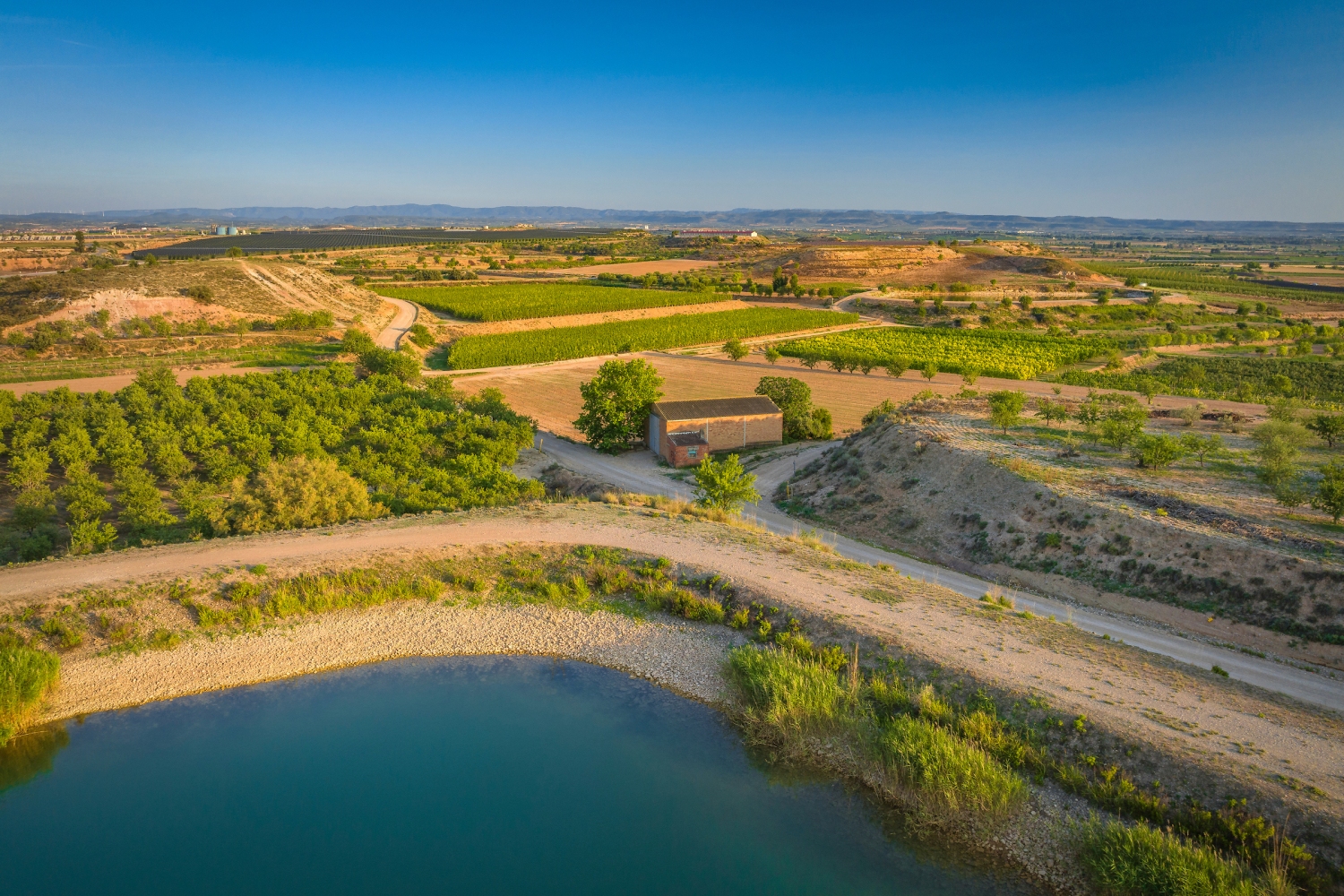 Turisme Pla d'Urgell (Aerial View Of Irrigated Fields Around The Bassella Reservoir And Tossal De L Infern Area Near Miralcamp Pla D Urgell Lleida Catalonia Spain_065)